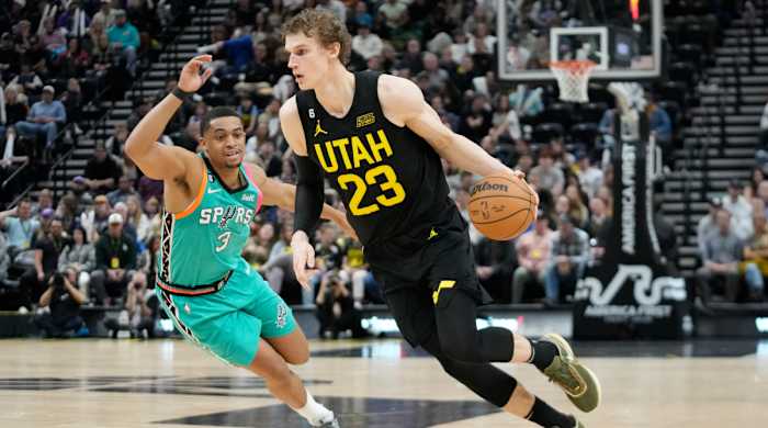 Jazz forward Lauri Markkanen tries to dribble past Spurs forward Keldon Johnson.